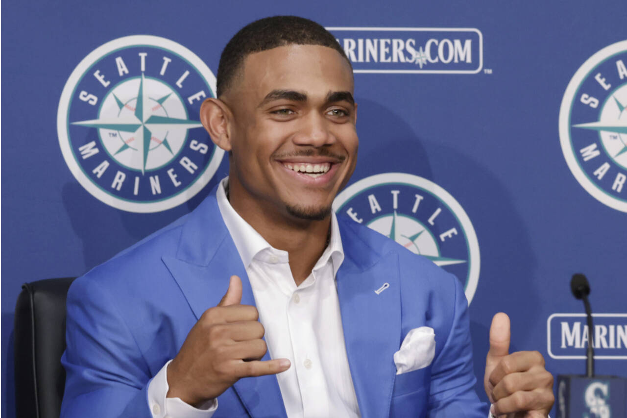 John Froschauer/The Associated Press Seattle’s Julio Rodriguez gestures at the end of a news conference held the day after announcing he signed a multi-year contract on Saturday in Seattle.