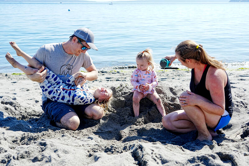 The Irick family — dad Chance, daughters Maeve, 4, and June, 18 months, and mom Sarah, all from Port Townsend — spend the last day of summer vacation at the beach at Fort Worden State Park on Monday. Maeve starts school today. (Steve Mullensky/for Peninsula Daily News)