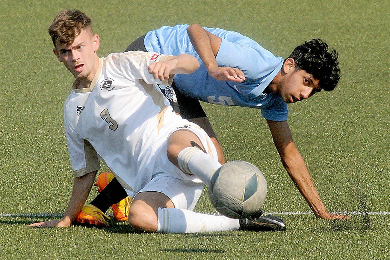 KEITH THORPE/PENINSULA DAILY NEWS
Peninsula's Alfie Tucker, front, gets tangled on the pitch with Pierce's Manuel Lomeli during Saturday's match at Wally Sigmar Field.