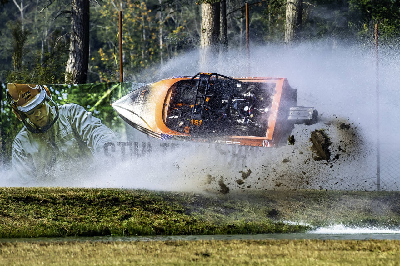 Courtesy of Wildlight Motorsport Photography
Driver Kyle Patrick and navigator Darryn Todd, the 151 Psycho unlimited class boat go flying into a fence at the Extreme Sports Park outside of Port Angeles this weekend during the second running of the American Spring Boat races. Both driver and navigator were uninjured and returned to race in the finals.