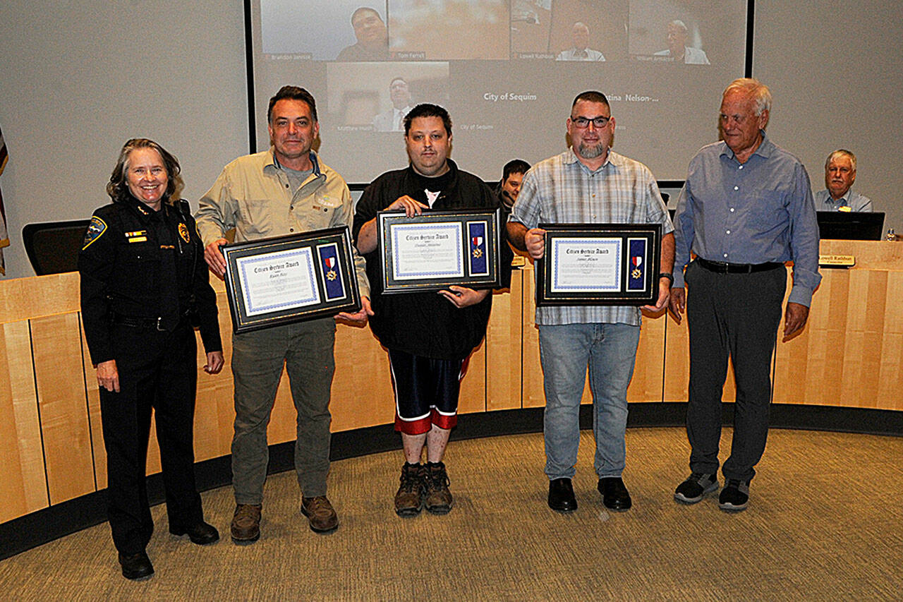 Matthew Nash/Olympic Peninsula News Group
For their efforts to help a Sequim police officer being attacked in May, from left, Ryan Ross, Daniel Anselmo, and James “Mike” Blouin were honored with Citizen Commendation Awards by Sequim Police Chief Sheri Crain and Sequim Mayor Tom Ferrell.