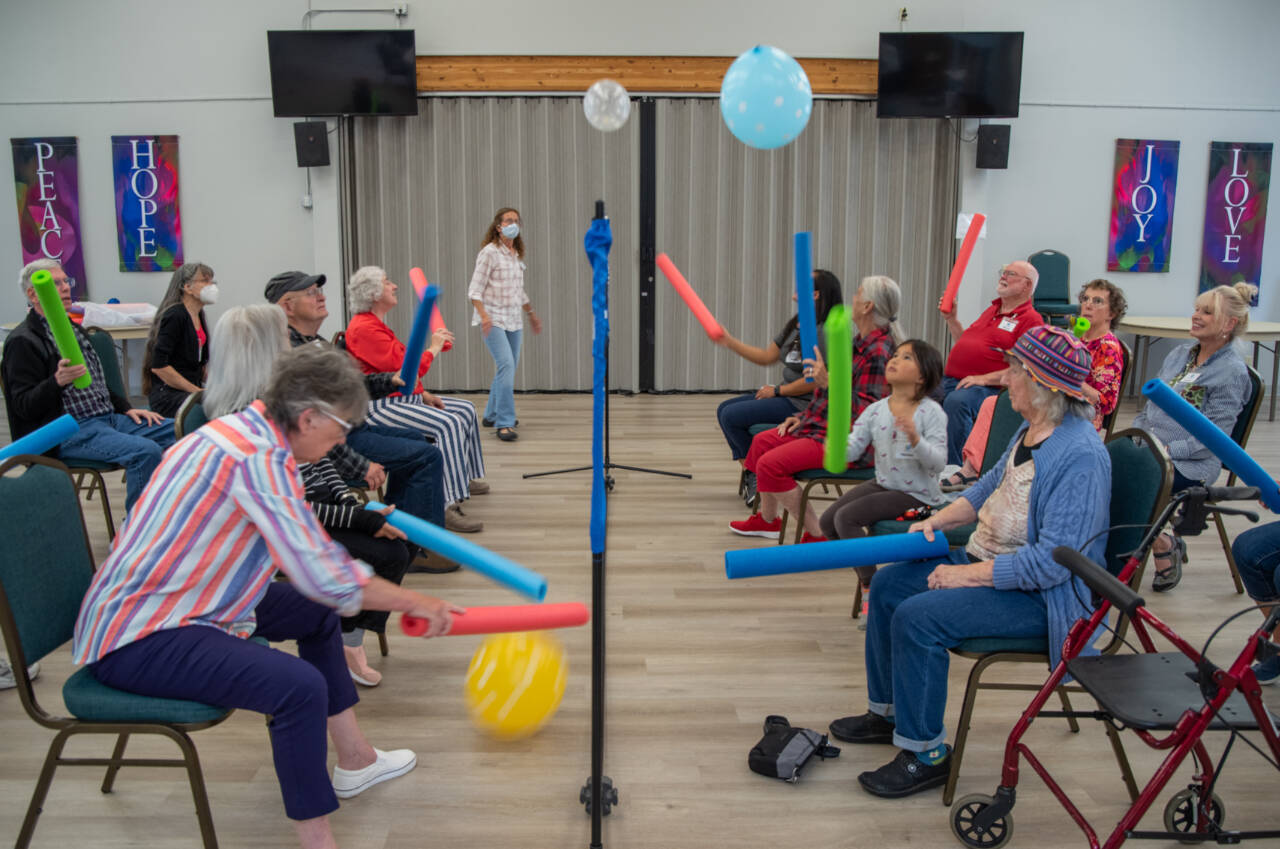 Volunteers and people living with memory loss play a variation of balloon volleyball during a Tim’s Place gathering at Trinity United Methodist Church in Sequim. (Emily Matthiessen/Olympic Peninsula News Group)