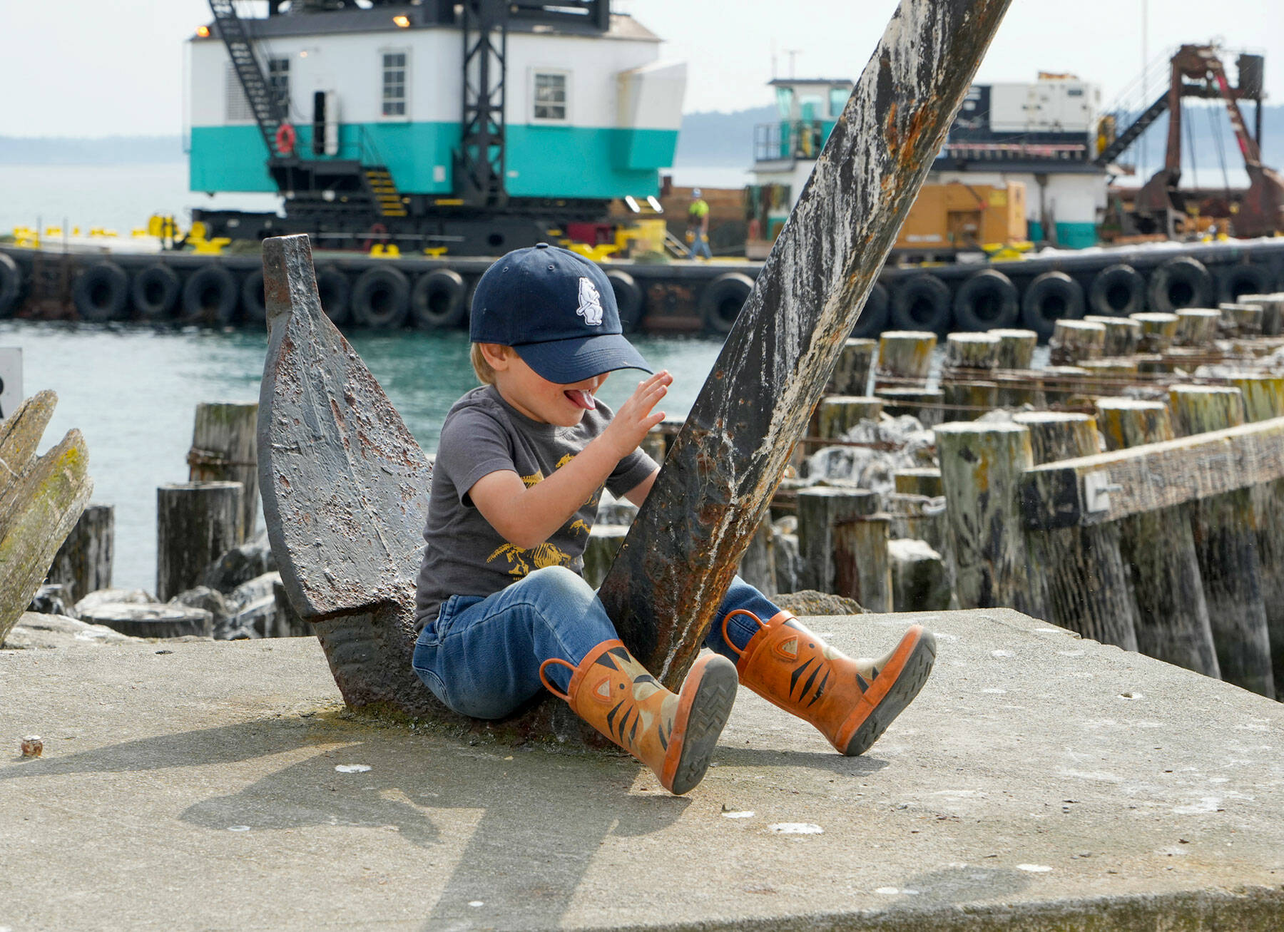 Max Albert Ruffo, 4½ from Port Townsend, rides the anchor fluke like a bucking bronco while visiting Point Hudson with his grandma on Tuesday. (Steve Mullensky/for Peninsula Daily News)