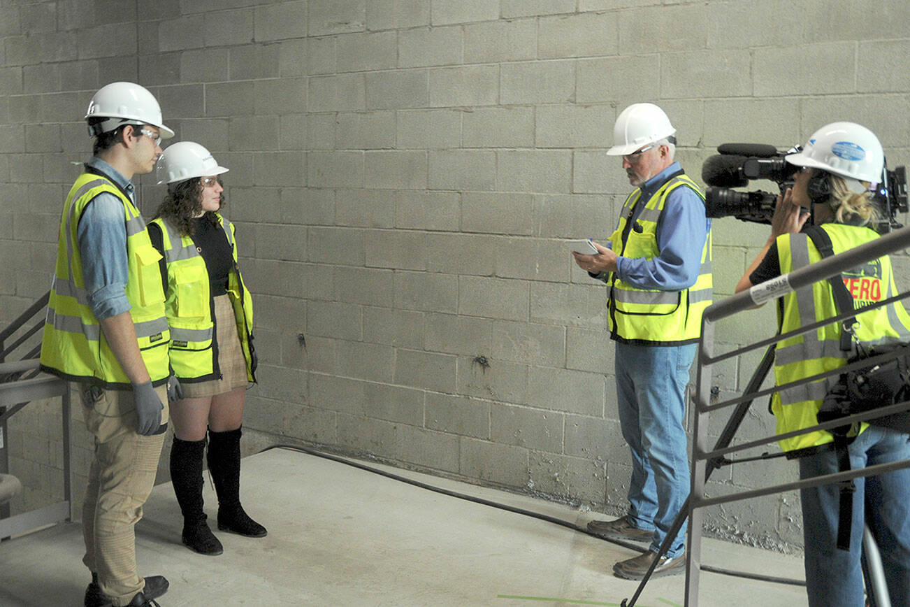 KEITH THORPE/PENINSULA DAILY NEWS
Peninsula College students Riley Baermann, left, and Avery Saul, both of Port Angeles, talk about their upcoming involvement in the Media Tech and Stagehand Training School with KING-5 television interviewer Eric Wilkinson and camera operator Robin Lile during a taping session at Field Hall Arts & Events Hall on Thursday in Port Angeles. The training school, which features a new media technicians certificate program, will be hosted by Field Hall and accredited by the college. The program will be funded through a $1 million grant by the Department of Commerce’s Economic Development Administration to develop skills that can be put to living-wage jobs on the North Olympic Peninsula.