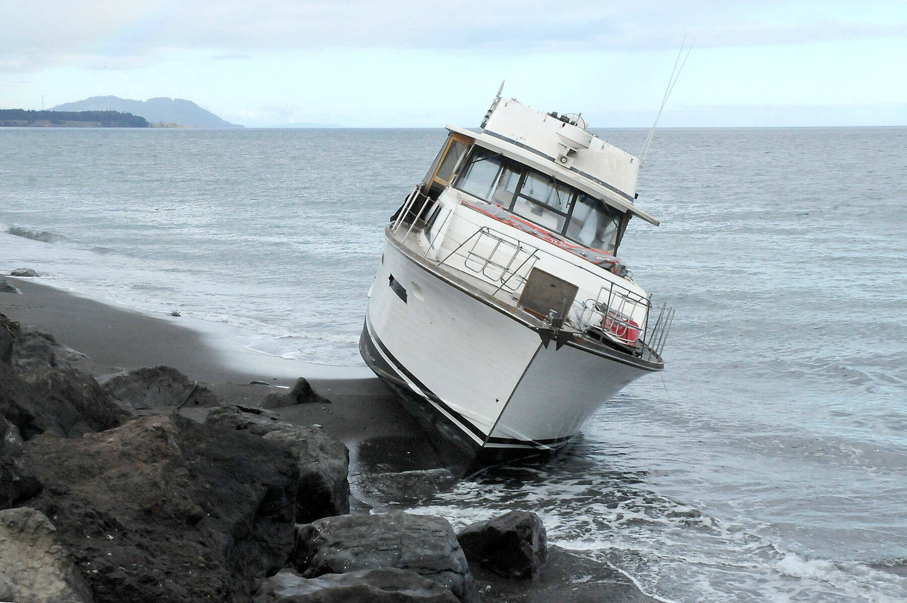 A pleasure boat sits aground on the north side of Ediz Hook in Port Angeles on Friday. (Keith Thorpe/Peninsula Daily News)