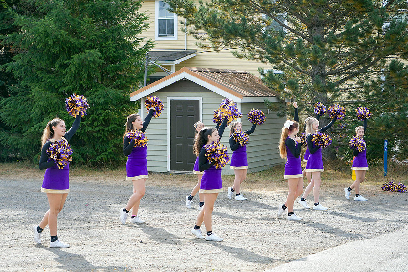 The Quilcene High School cheer squad practices a routine before the start of the Quilcene Fair parade on Saturday. (Steve Mullensky/for Peninsula Daily News)