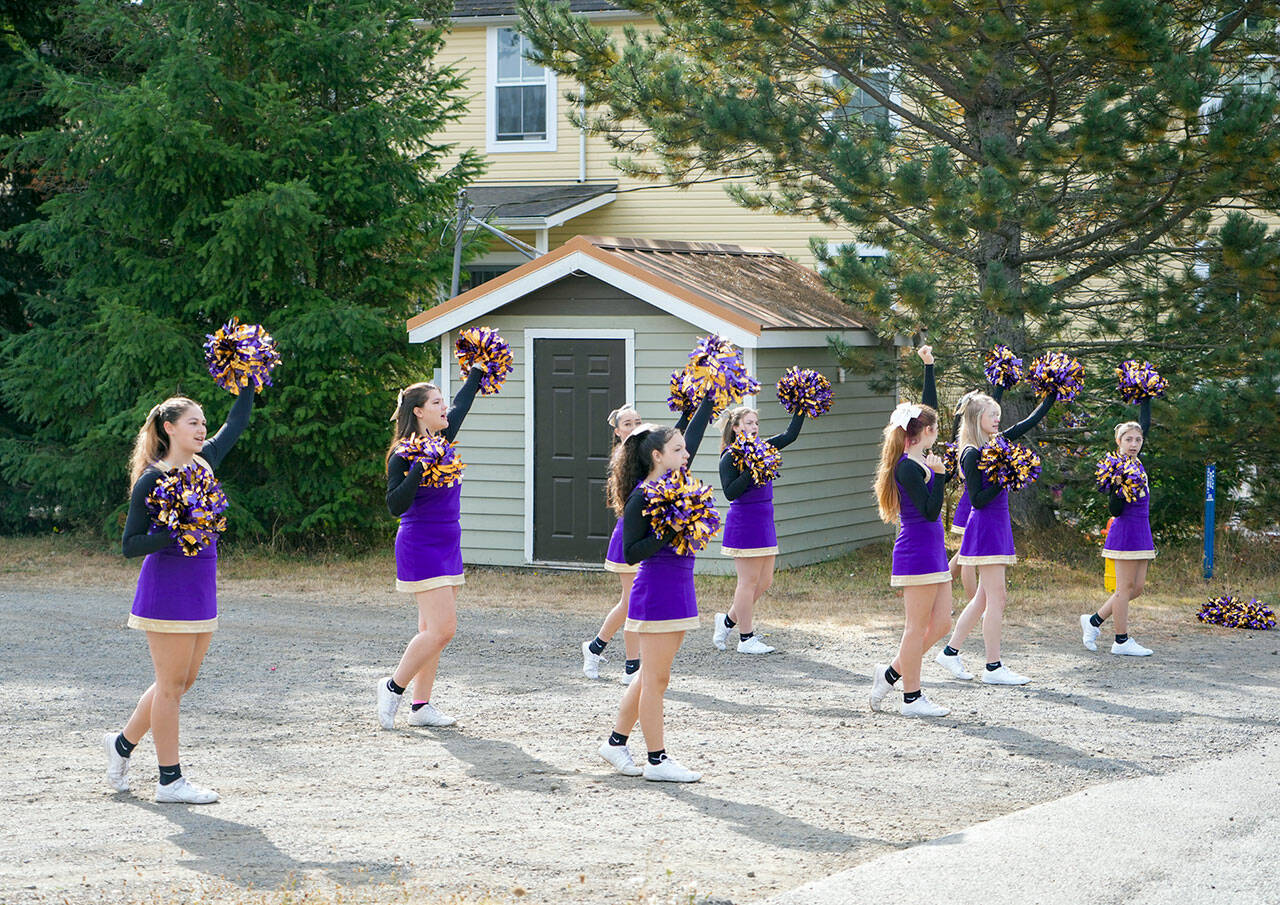 The Quilcene High School cheer squad practices a routine before the start of the Quilcene Fair parade on Saturday. (Steve Mullensky/for Peninsula Daily News)