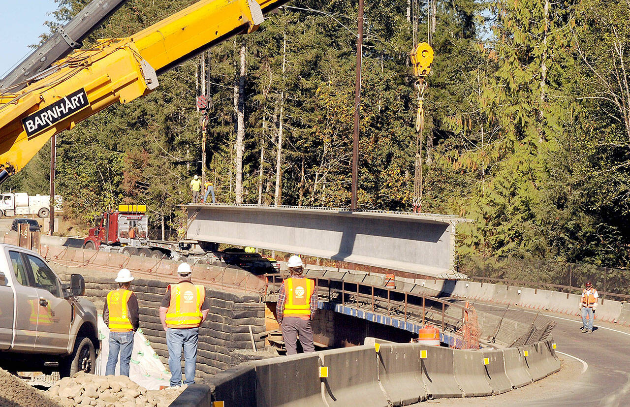 A pair of construction cranes prepare on Tuesday to hoist the second of eight 177-foot, 200,000-pound concrete girders that will support a new bridge being constructed on U.S. Highway 101 over Indian Creek southwest of Port Angeles. (Keith Thorpe/Peninsula Daily News)