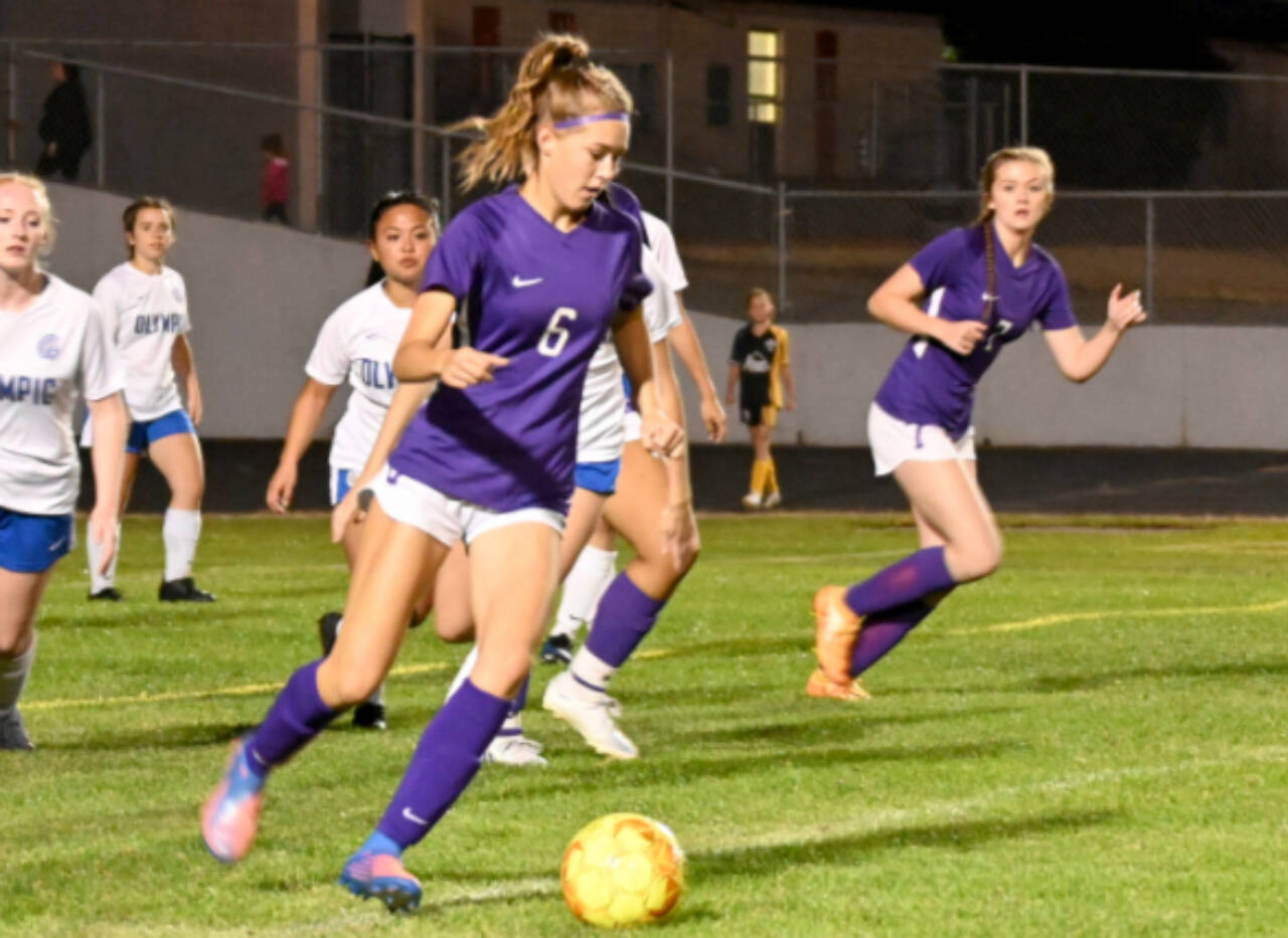 Sequim High’s Teagen Moore, left looks for a teammate as Sequim’s Eve Breithaupt looks in early in the second half of the Wolves’ 6-1 win over Olympic on Sept. 20. (Michael Dashiell/Olympic Peninsula News Group)