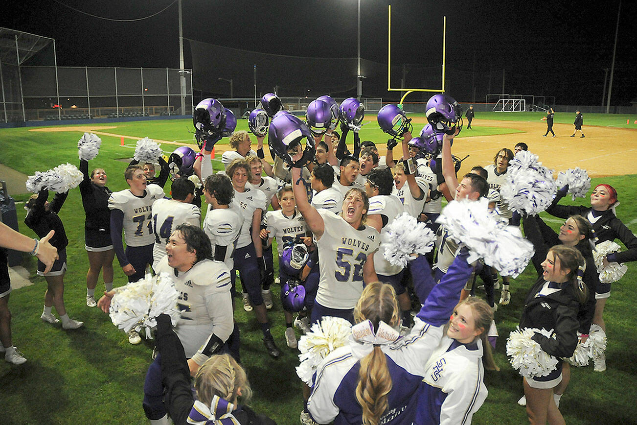 KEITH THORPE/PENINSULA DAILY NEWS
Members of the Sequim Wolves football team and cheer squad celebrate Friday night's 36-32 come-from-behind victory over the Port Angeles Roughriders at Port Angeles Civic Field.