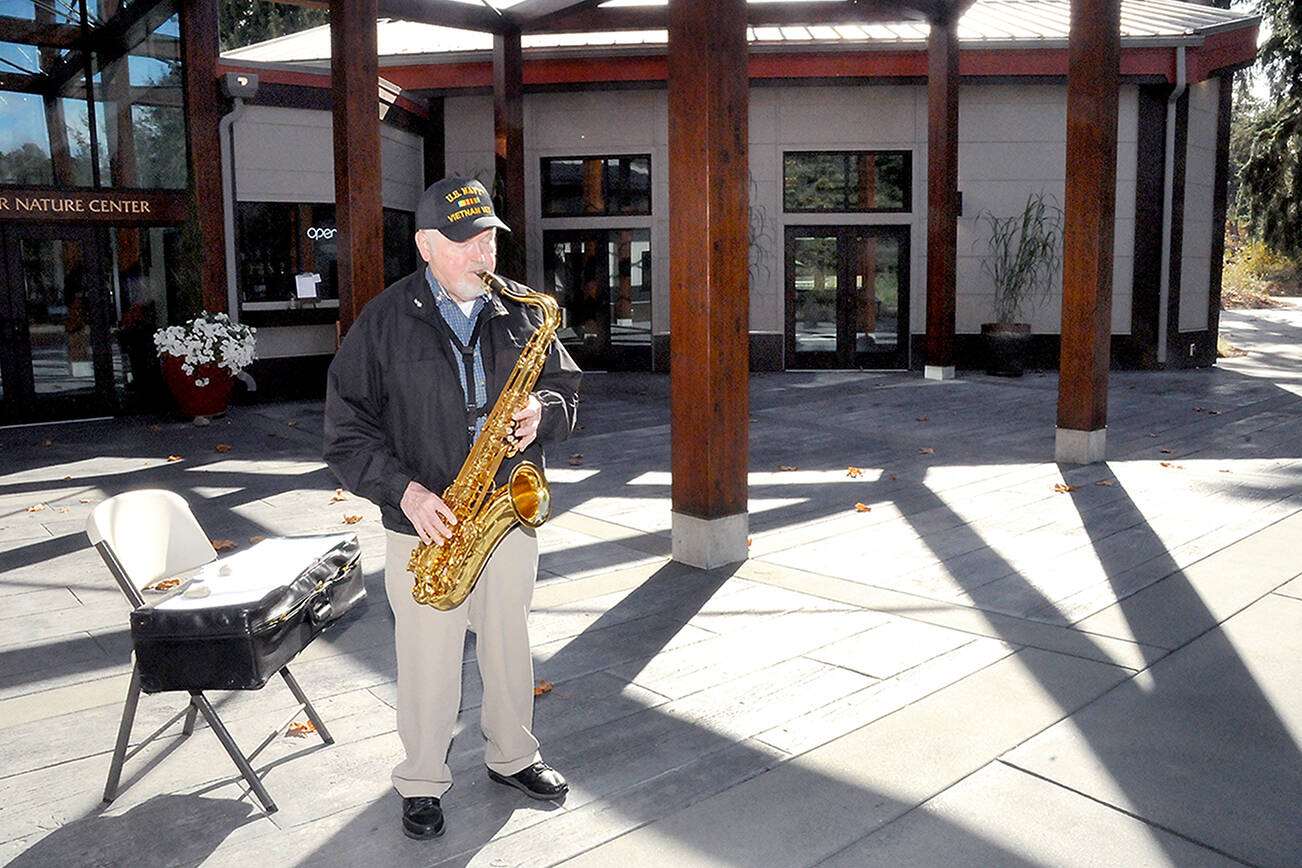 John Zuermer, 86, of Sequim plays his saxophone on the patio plaza at the Dungeness Nature Center at Railroad Bridge Park in Sequim. Zuermer, who regularly performs at the center from 11 a.m. to noon on Wednesdays and Saturdays, said he decided it would be a fun thing to do, keeping up his musical skills while playing for anyone who happened by. (Keith Thorpe/Peninsula Daily News)