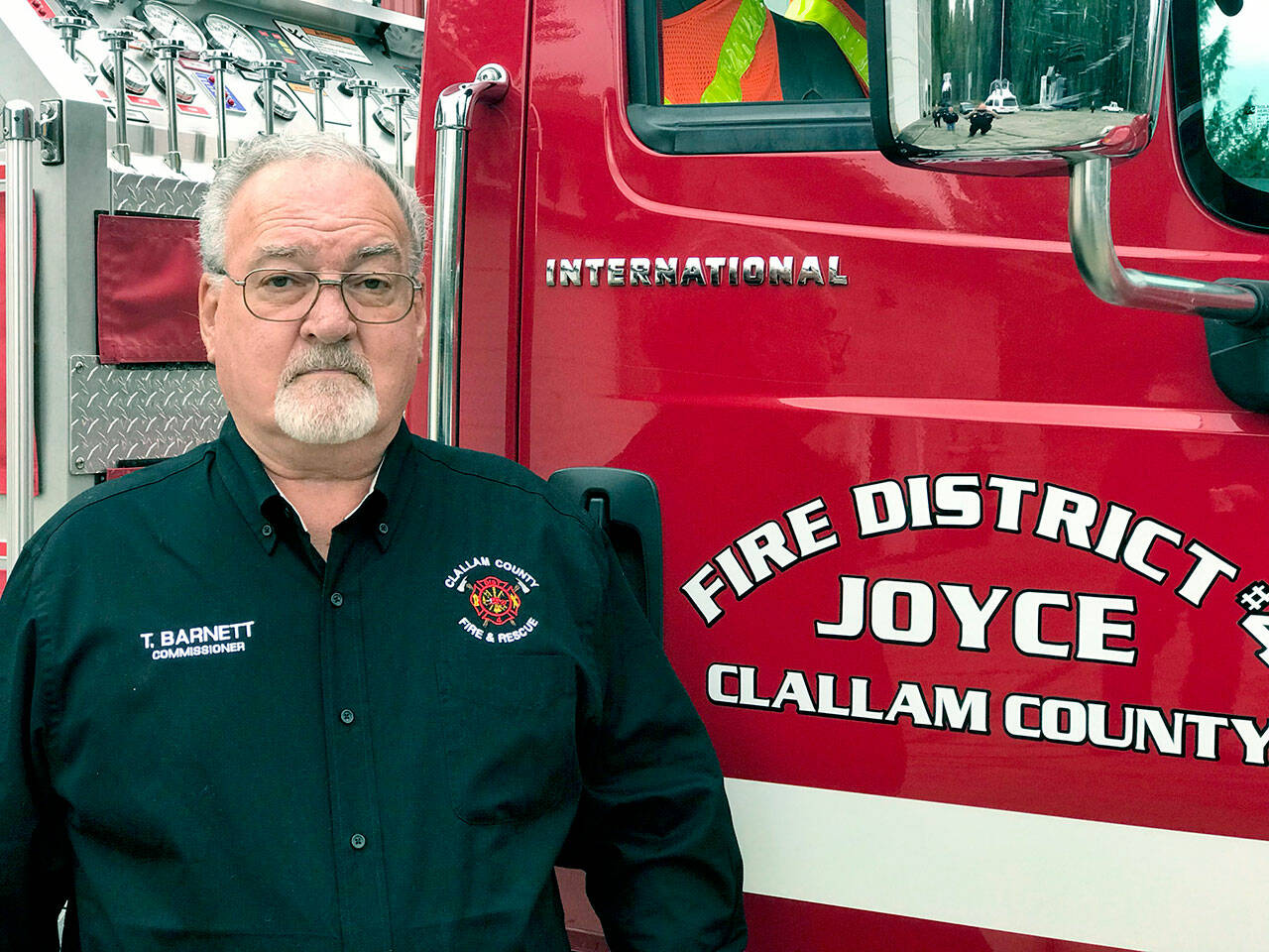 Clallam County Fire District No. 4)  
The late Terry Wayne Barnett, who was a Joyce Fire District Commissioner and chair of the building committee, is pictured standing in front of one of the fire trucks he wanted to be housed in the planned apparatus barn in Joyce.