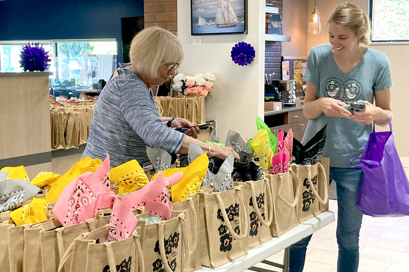 Port Townsend Main Street Program Promotion Committee members Sue Arthur, left, and Jennifer Wake help make 500 goodie bags filled with donations from local merchants and sponsors to be sold at Thursday’s Girls’ Night Out headquarters at Vintage by Port Townsend Vineyards, 725 Water St., starting at 11 a.m. Proceeds from the goodie bag sales support the nonprofit Main Street Program and the Jefferson Healthcare Foundation’s fund to help people in need receive breast and cervical cancer screenings and other services. The event will feature a day and night of shopping at 38 businesses with many open later than usual. The theme is the 1960s “You Go Go Girl!” The wrap party will be at 6 p.m. at Vintage by Port Townsend Vineyards. For more, see ptmainstreet.org.