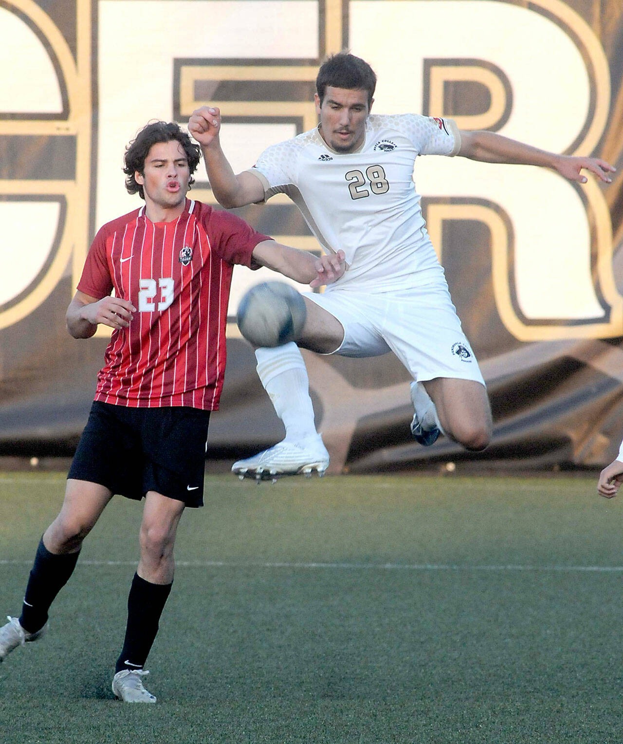 KEITH THORPE/PENINSULA DAILY NEWS
Peninsula's Kai Biegler, right, leaps high to keep the ball away from Everett's River Stewart during Saturday's match at Peninsula College in Port Angeles.