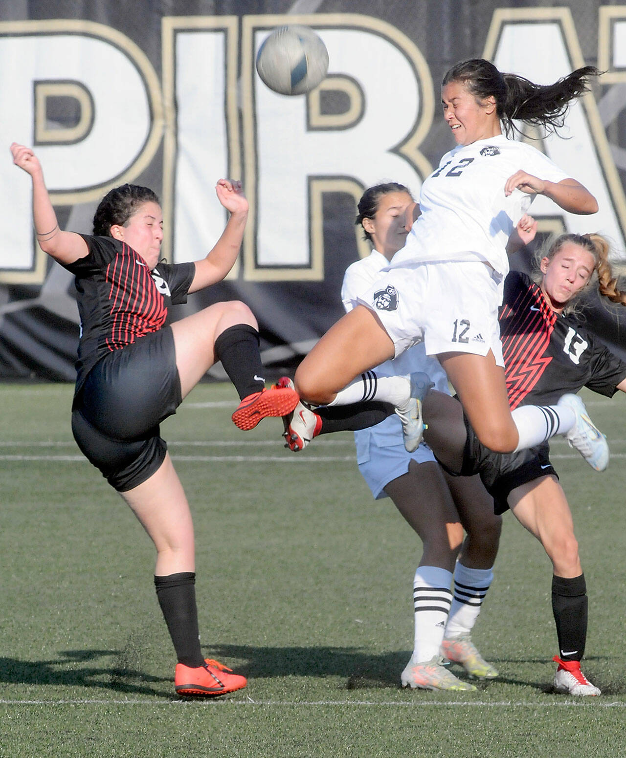 Peninsula’s Keilee Silva fights for a header with Everett’s Giovanna Occhiallini, left, and Paige Runcorn right as Silva’s teammate, Kira Meechudhone, follows behind on Saturday at Wally Sigmar Field in Port Angeles. (Keith Thorpe/Peninsula Daily News)