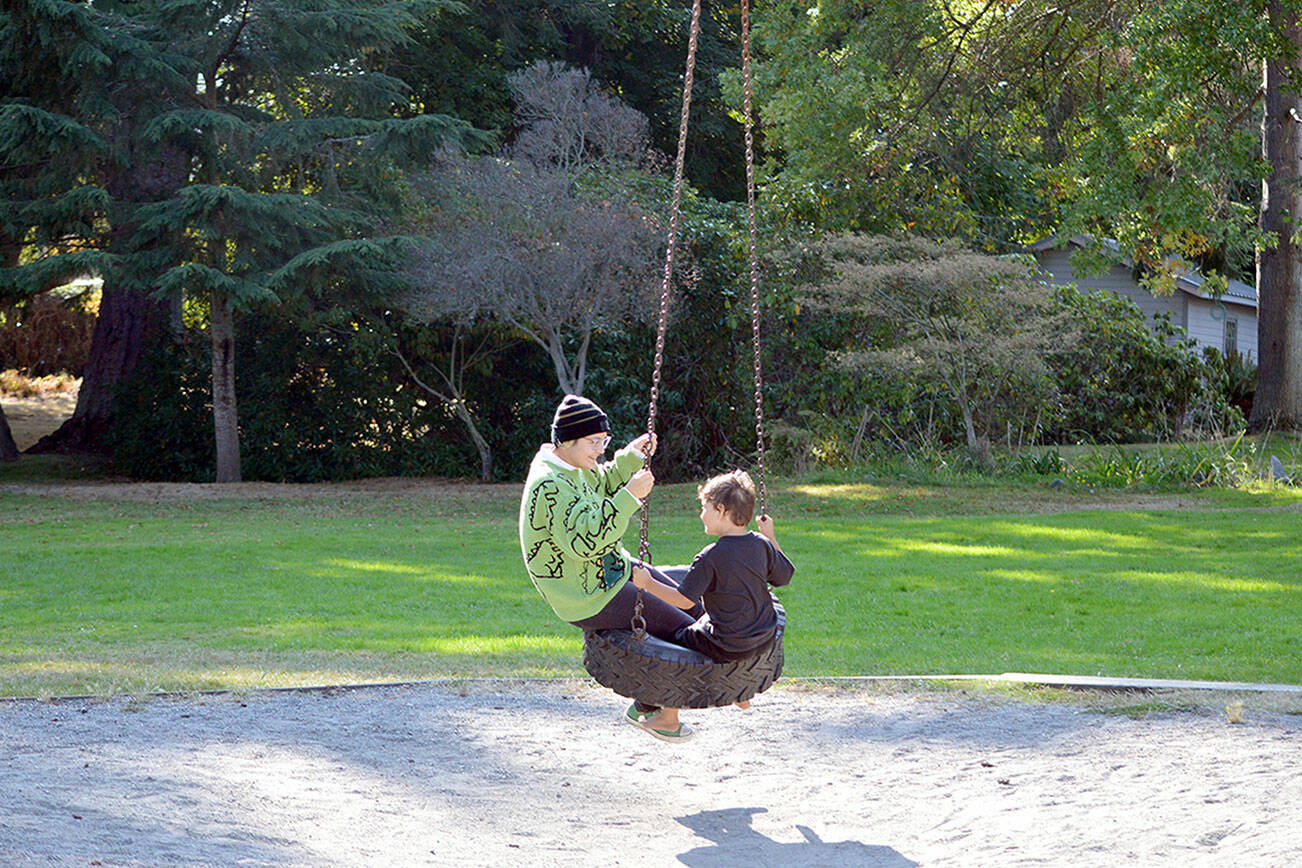 Fiona Krienke, 19, and her brother Hawk, 6, take a spin on the tire swing at Chetzemoka Park in Port Townsend. The 118-year-old city park is named after Chief Chetzemoka, the 19th century S’Klallam leader. (Diane Urbani de la Paz/Peninsula Daily News)