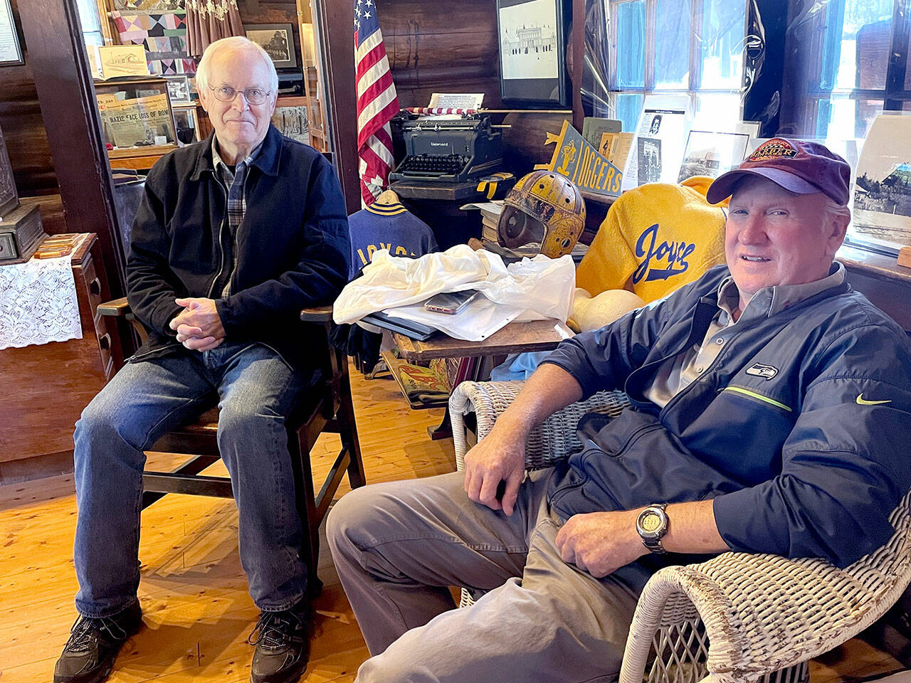 Dan Dafoe, left, and Terry Kahler, right, wrote a book, “Crescent School District 313, Joyce, Washington, 1922-1924,” that commemorates the history of the district, whose centennial will be celebrated Saturday. (Paula Hunt/Peninsula Daily News)