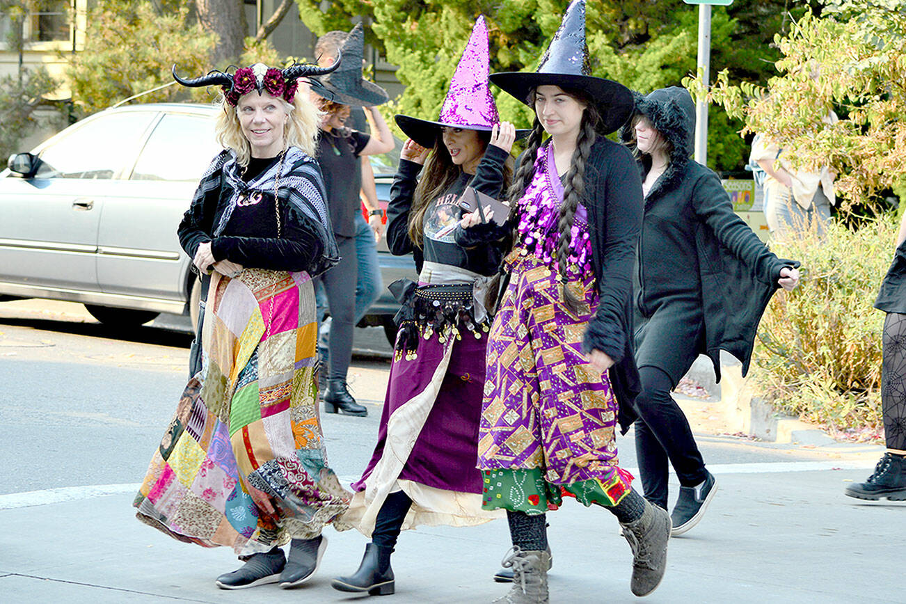 From left, Nancy Mandell, Julia Escobedo and Mandy Escobedo partake in the inaugural Witches’ Walk through downtown Port Townsend on Saturday. Some 50 witches — women, children and men among them — assembled at Haller Fountain and sashayed through traffic to Pope Marine Park. (Diane Urbani de la Paz/For Peninsula Daily News)