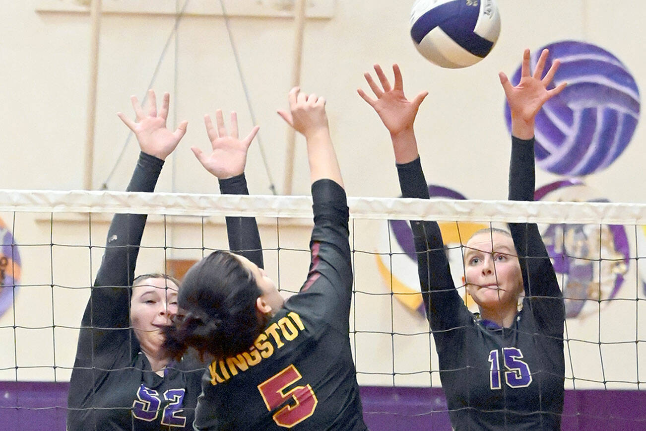 Sequim's Sammie Bacon, left, and Kendall Hastings attempt to defend against a shot by Kingston's Grace Mosco as Kingston libero Lily Wright looks on during the Wolves 3-0 senior night victory on Thursday.