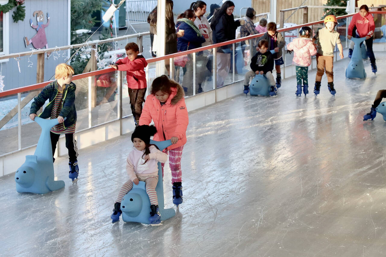 The Winter Ice Village in downtown Port Angeles is open for another season of ice skating. Tiadosa Tom, age 9 in pink, and her cousin Annabella Mason, age 4, are glad the Ice Village finally opened on Friday. (Dave Logan/For Peninsula Daily News)