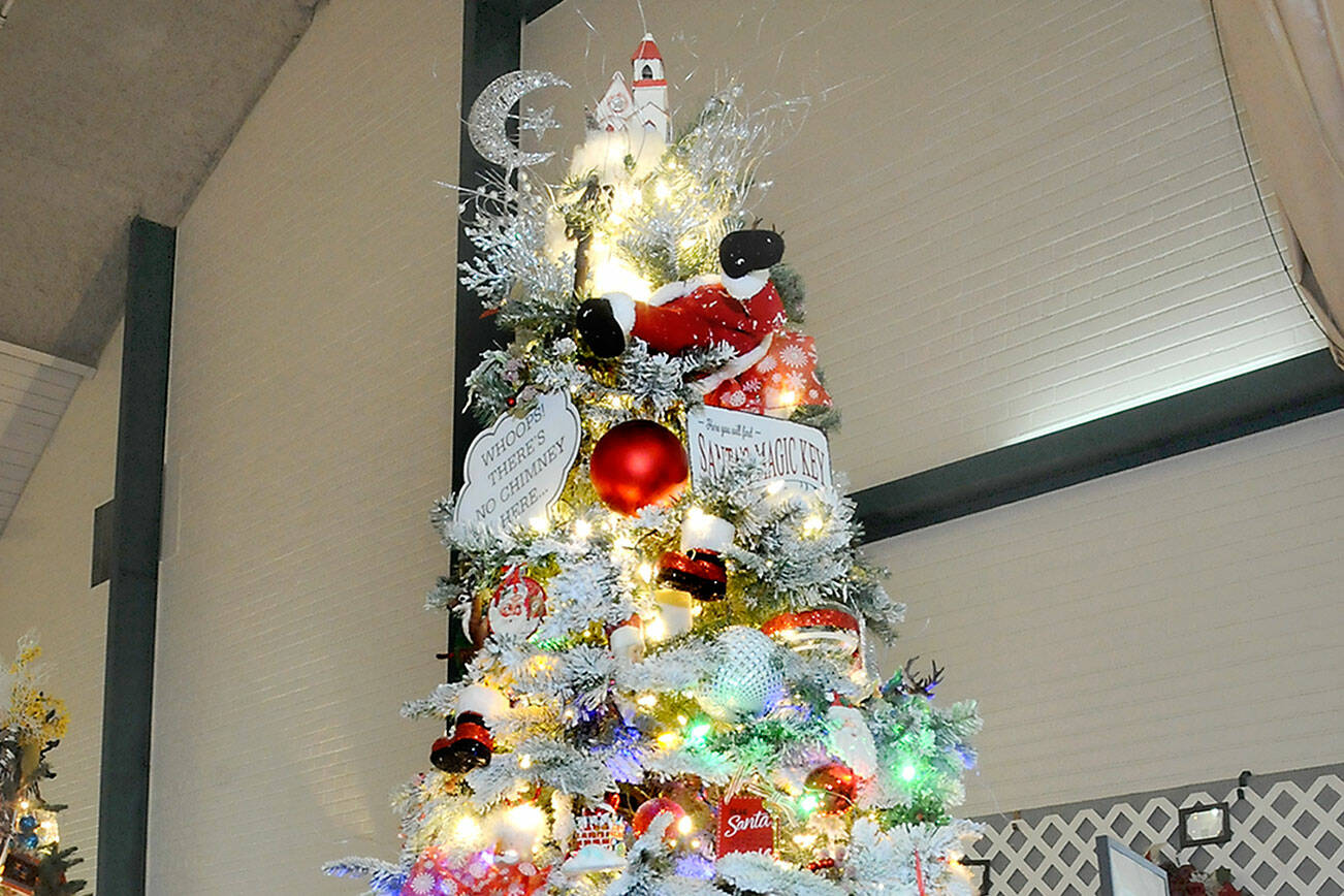 A Christmas tree titled “Santa’s Magic Key” stands tall at the 32nd annual Festival of Trees at Vern Burton Community Center in Port Angeles on Friday after it fetched the highest bid during Friday night’s gala auction benefiting the Olympic Medical Center Foundation. (Keith Thorpe/Peninsula Daily News)
