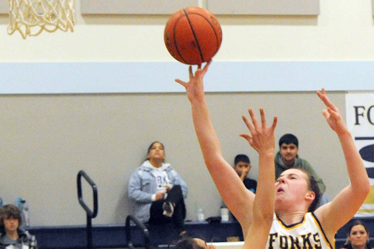 Lonnie Archibald/for Peninsula Daily News
Forks' Keira Johnson scores over North Beach's Malia Cox in Forks on Wednesday evening where Forks defeated North Beach 59-15.