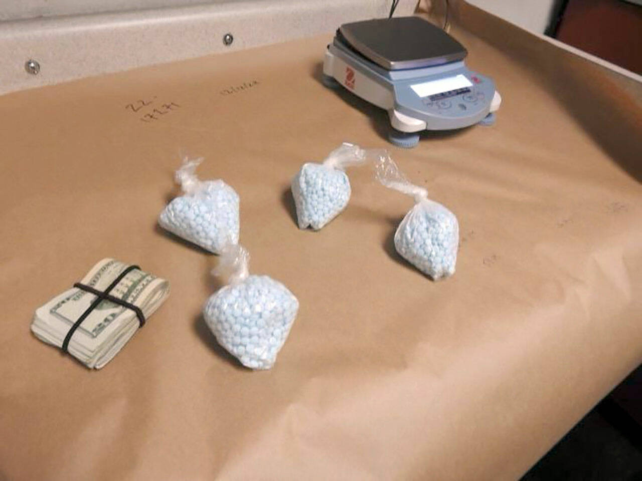 Olympic Peninsula Narcotics Enforcement Team displays drugs and money fter an arrest.