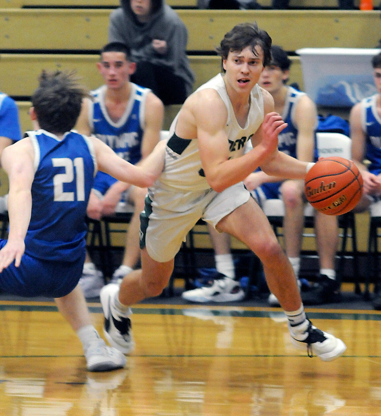 Port Angeles’ Parker Nickerson, right, dribbles past Olympic’s Jackson Barrett on Tuesday night in Port Angeles. (Keith Thorpe/Peninsula Daily News)