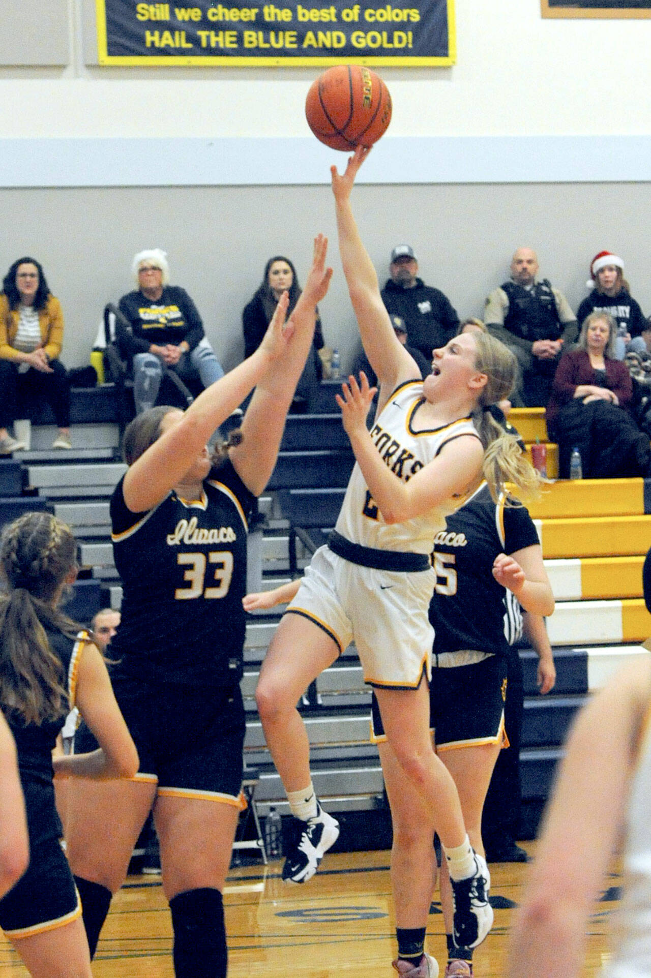 Forks’ Kadie Wood scores over Ilwaco’s Olivia McKinstry during the Spartans’ 75-64 win over Ilwaco at home Wednesday. (Lonnie Archibald/for Peninsula Daily News)