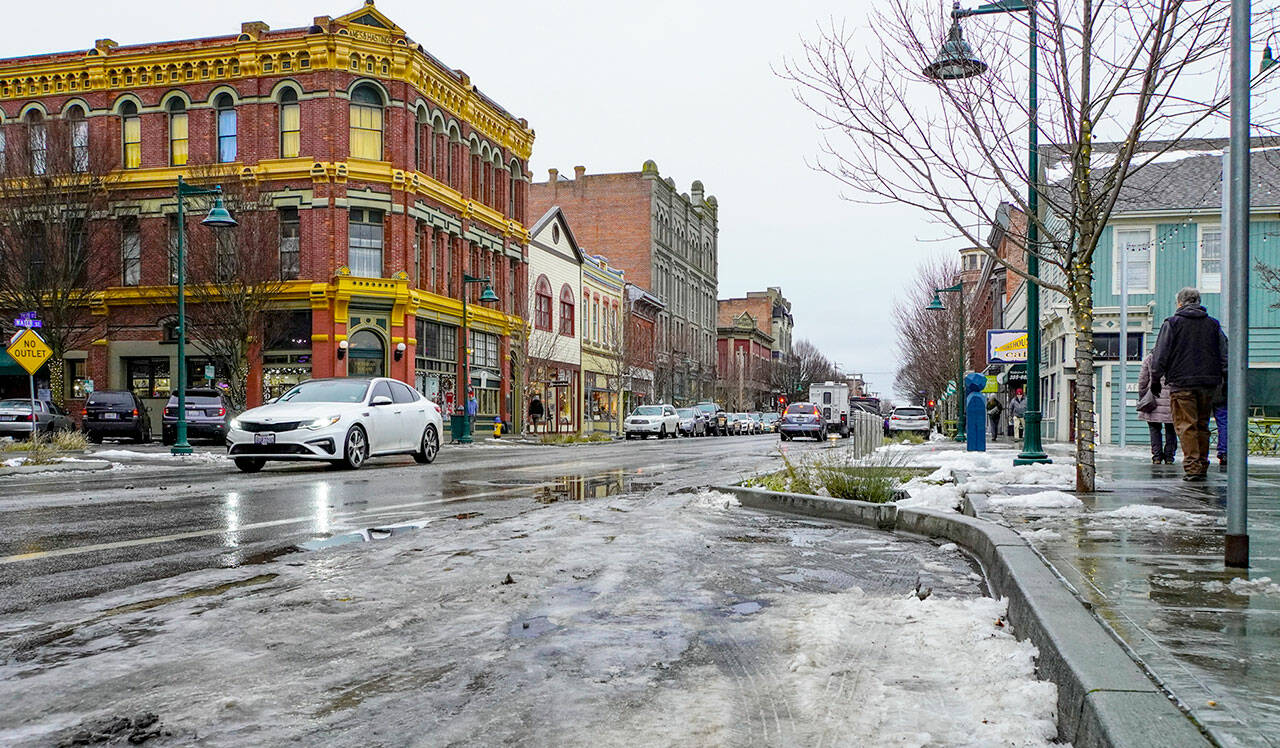 After days of frozen streets and sidewalks the downtown Port Townsend business district is covered with slush and puddles after an overnight rain on Thursday and Friday morning. The temperature climbed to 37 degrees at midday Friday. (Steve Mullensky/for Peninsula Daily News)