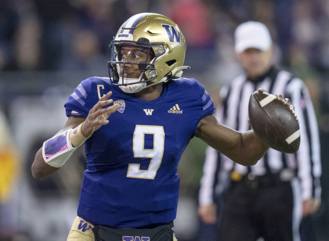 Washington quarterback Michael Penix Jr. looks to pass against Colorado on Nov. 19 in Seattle. Penix, college football’s leading passer, leads the No. 12 Huskies against No. 21 Texas in the Alamo Bowl tonight. (Stephen Brashear/The Associated Press)