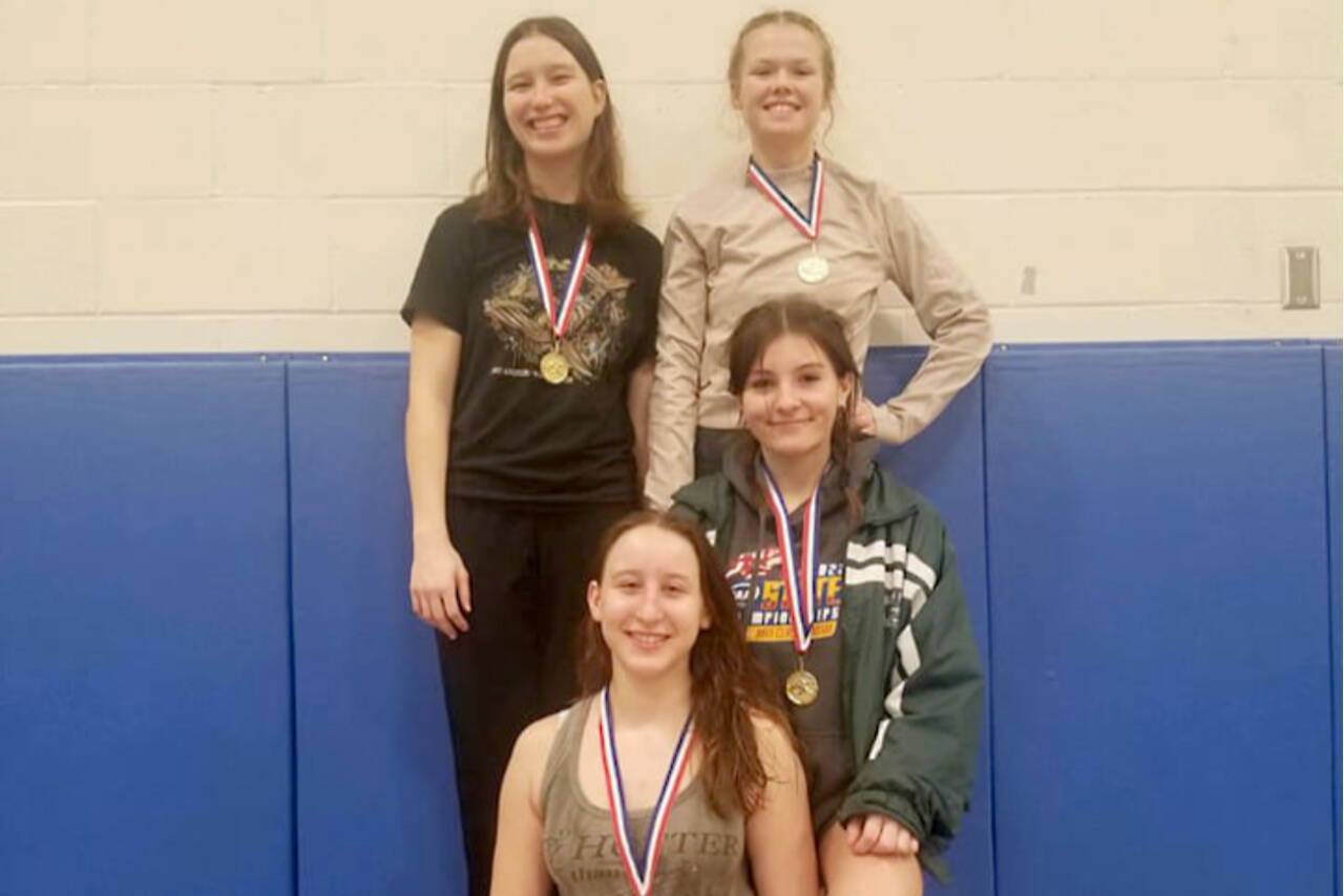 Courtesy of Port Angeles wrestling
Members of the Port Angeles girls wrestling team celebrate their first-place medals from the Hawkins Memorial Tournament held in Belfair Tuesday and Wedneasday. Clockwise, from top left, are Julia Baeder, Faye Duchs, Natalie Johnson and team captain Willow Harvey. Not pictured is team member Sam Smith, who picked up a fourth-place medal.