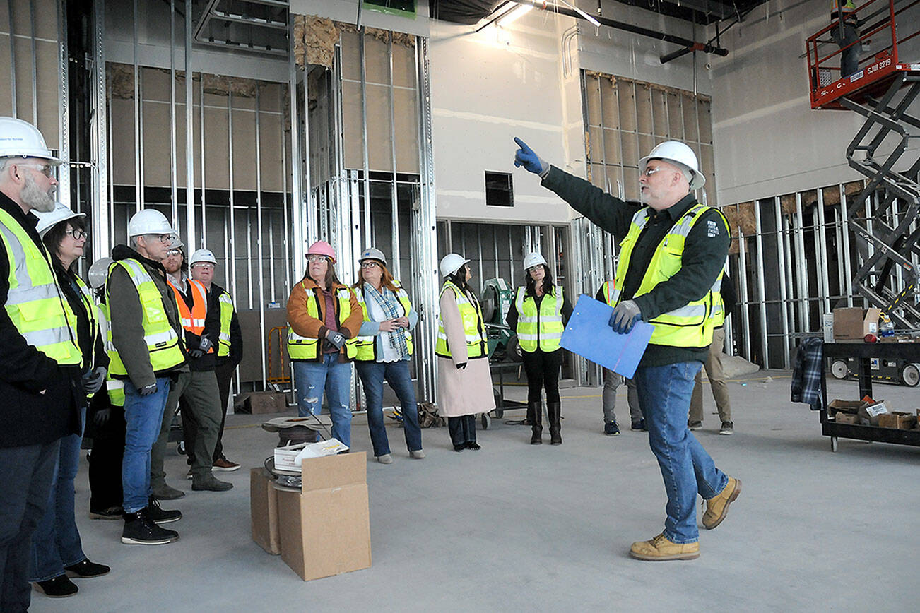 KEITH THORPE/PENINSULA DAILY NEWS
Chris Fidler, project director of the Field Arts and Events Hall, points out features of the under-construction building during a tour with members of the Clallam County Economic Development Council on Friday. The building, part of the much larger Port Angeles Waterfront Center project, will feature a performing arts center, a convention hall, meeting space, a coffee shop and art gallery. PDN Publisher Terry Ward, is chairman of the Clallam County Economic Development Corp. board of directors.