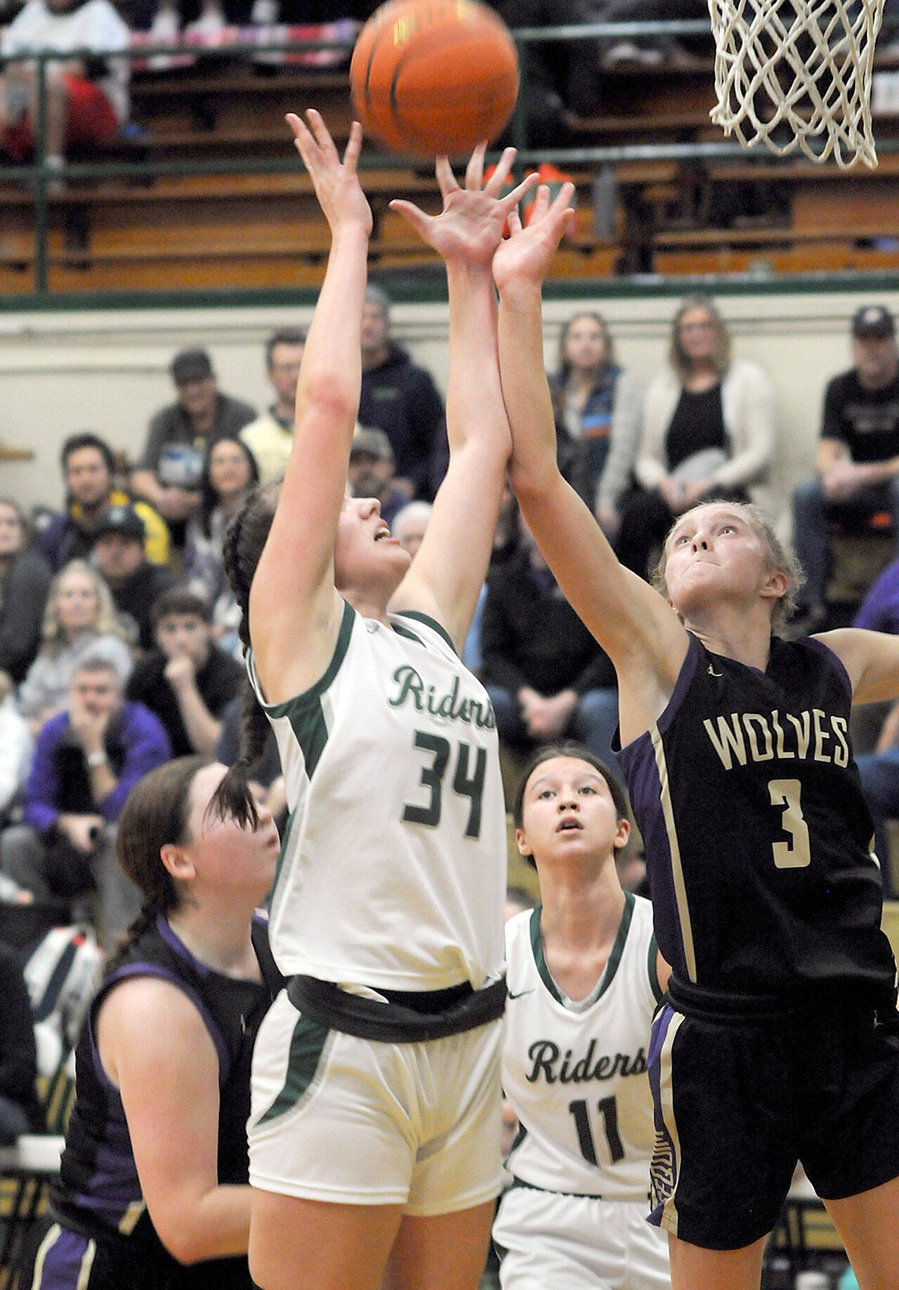 Port Angeles’ Lexie Smith, left, and Sequim’s Jolene Vaara vie for a rebound as Sammie Bacon of Sequim, lower left, and Lindsay Smith, rear, look on during Tuesday’s game at Port Angeles High School. (Keith Thorpe/Peninsula Daily News)