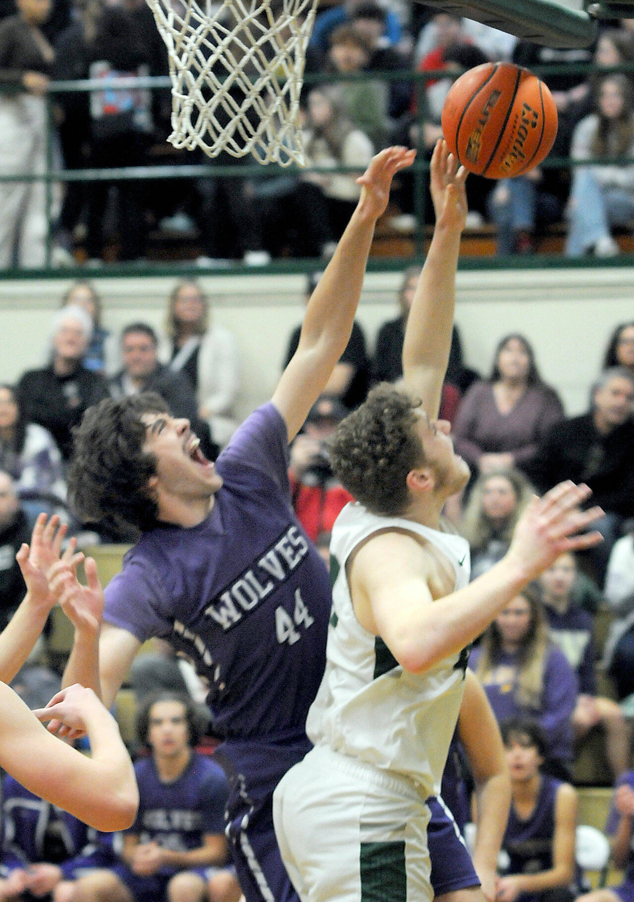 Sequim’s Cole Smithson, left, battles at the boards with Port Angeles’ Isaiah Shamp during Tuesday’s conference game at Port Angeles High School. (Keith Thorpe/Peninsula Daily News)