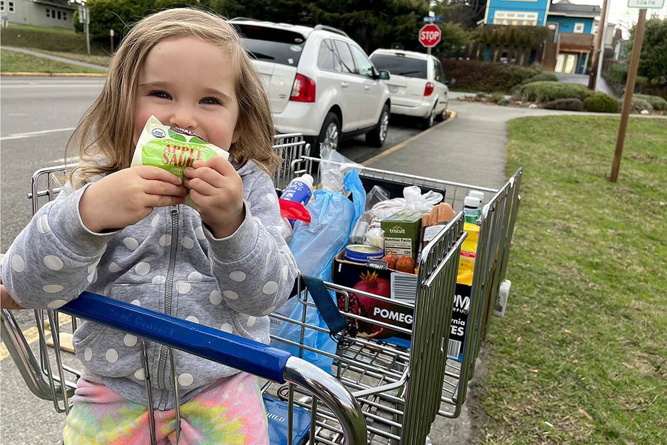 Lola Siegel, 3, enjoys some apple juice from the Port Townsend Food Bank, which has seen an uptick in clients over the past year. It was the first trip to the food bank for Lola and her father, Jonas Siegel, who said that he appreciated the organic and vegetarian options at the food bank. (Paula Hunt/Peninsula Daily News)