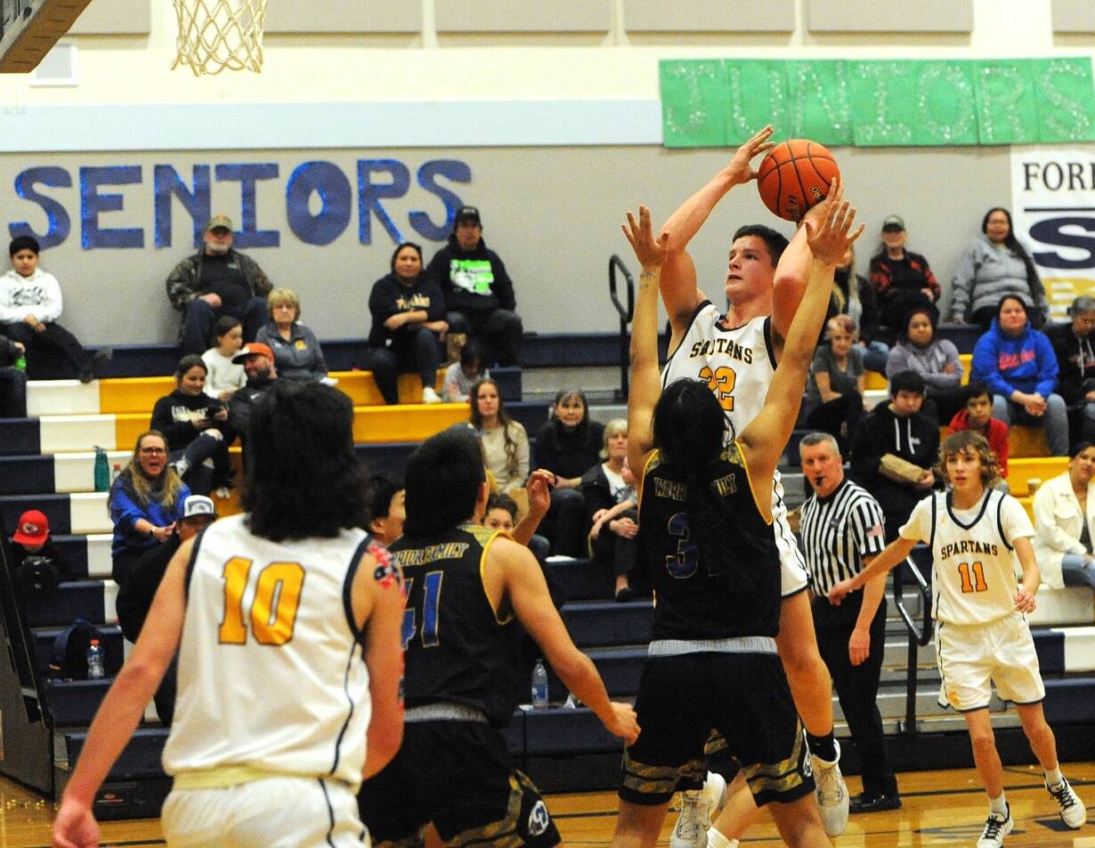 Brody Lausche (22), goes up for a jumper against Chief Leschi earlier this week. Lausche scored 11 points Friday night in a 58-21 victory over North Beach. Also in on the play are the Spartans’ Dylan Micheau (10) and Kyle Lohrengel (11). (Lonnie Archibald/for Peninsula Daily News)