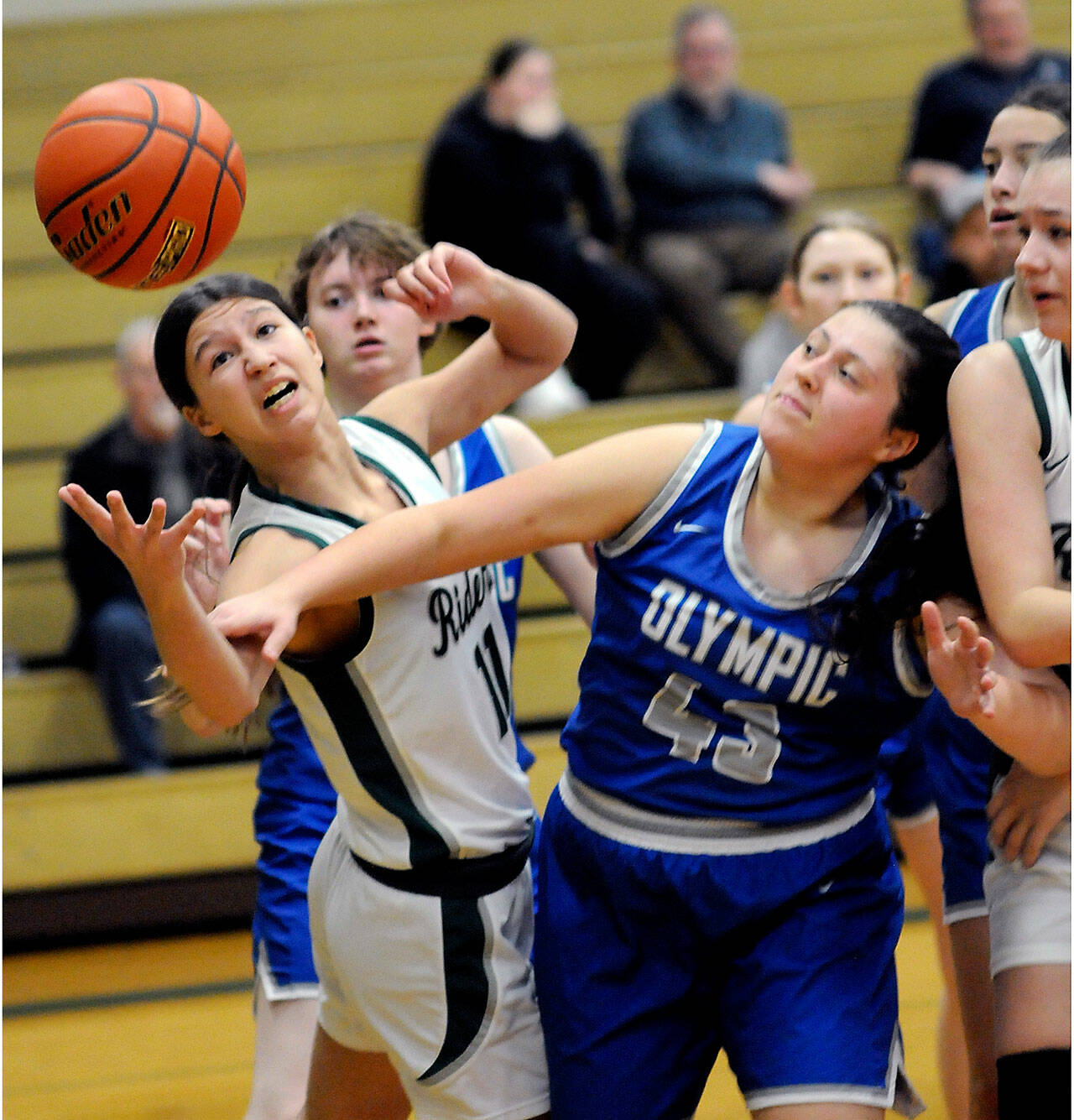 KEITH THORPE/PENINSULA DAILY NEWS Port Angeles’ Lindsay Smith, left, stretches for a rebound as Olympic’s Kylee Murphy reaches in on Thursday night in Port Angeles. Looking in at right is Lexie Smith of Port Angeles.