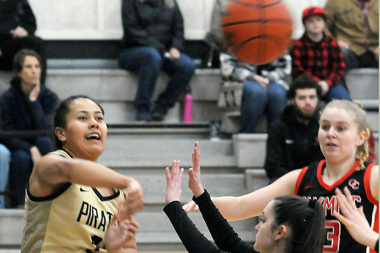 Keith Thorpe/Peninsula Daily News
Peninsula's Tatianna Kamae, left, passes over the head of Olympic's Madilyn Neil as Olympic's Alannah Northam looks on at right during Saturday's game in Port Angeles.