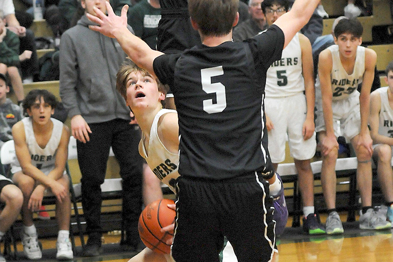 KEITH THORPE/PENINSULA DAILY NEWS
Port Angeles' Gus Halberg, left, waits for his chance at the basket as North Kitsap's Harry Davies, top, and Ethan Gillespie provide interference on Thursday at Port Angeles High School.