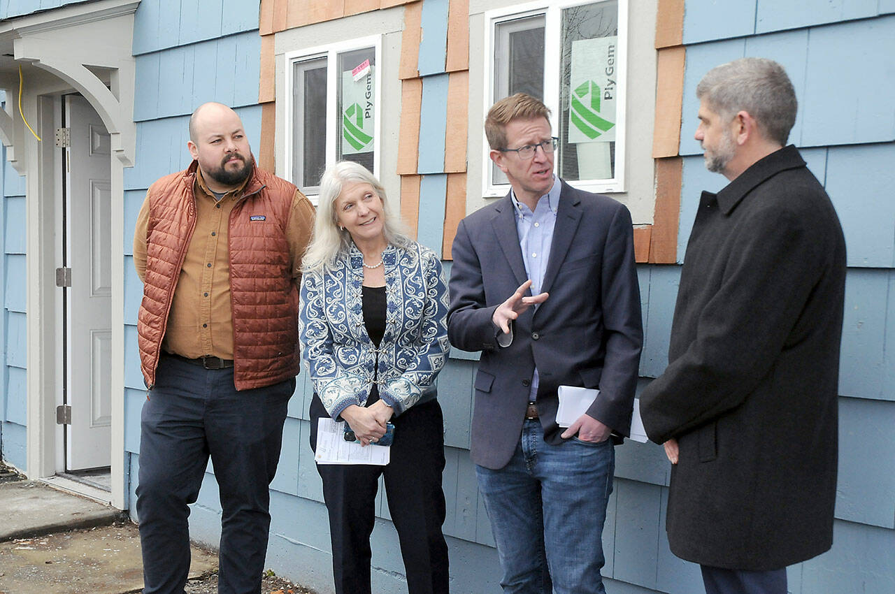 U.S. Rep, Derek Kilmer, second from right, talks with Clallam County Commissioner Mark Ozias, right, as Andrew Reiners, housing manager for Peninsula Behavaioral Health, left, and Shanna Bloom, PBH finanace controller, listen in during a tour on Friday of the former All-View Motel in Port Angeles. Kilmer said that unallocated American Rescue Plan Act funds are in danger of hving to be returned to the federal government. (KEITH THORPE/PENINSULA DAILY NEWS)