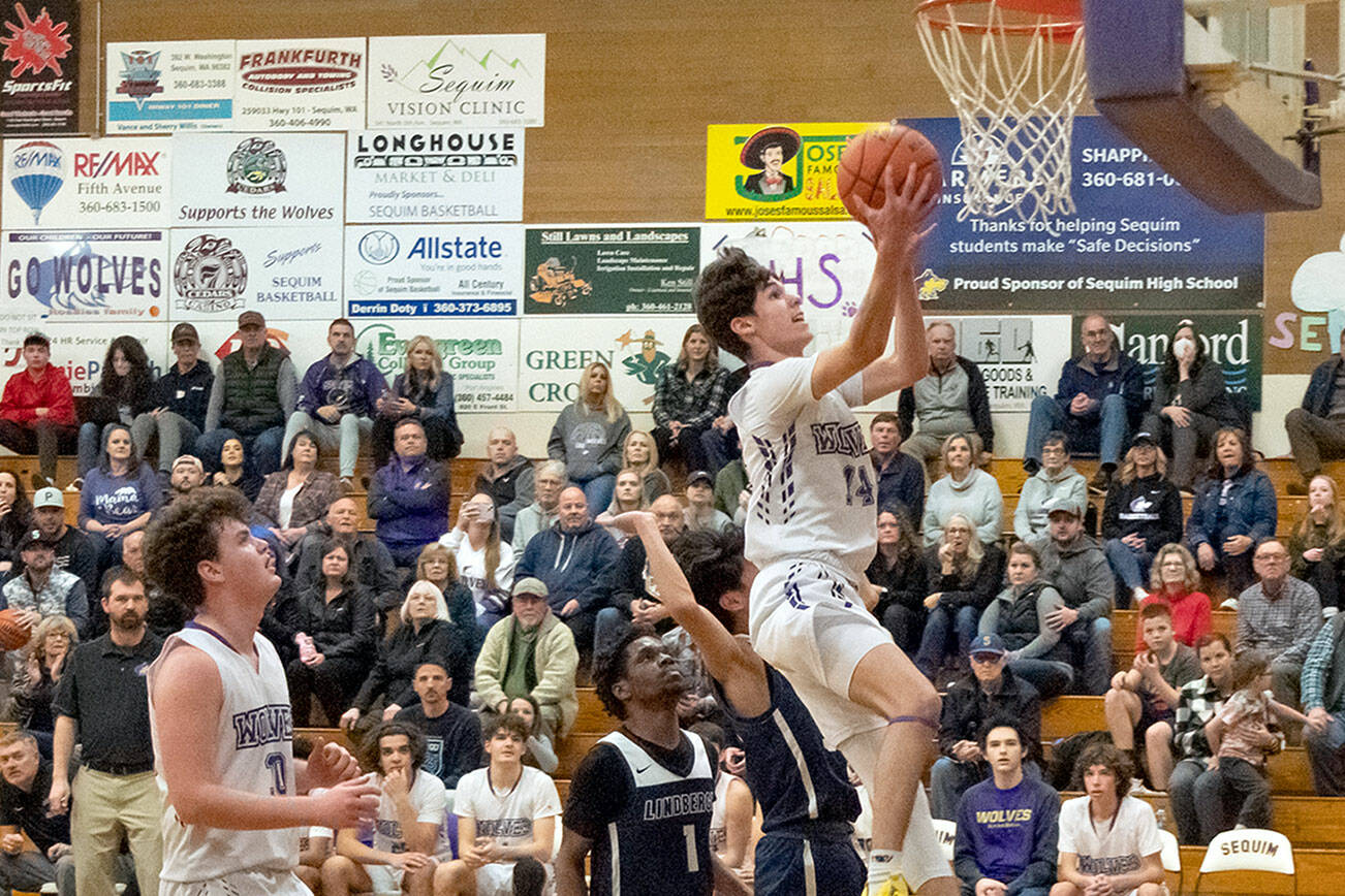 Emily Matthiessen/Olympic Peninsula News Group
Sequim's Vince Carrizosa drives the lane for a layup during the Wolves' 66-37 bi-district tournament win over the Lindbergh Eagles on Wednesday.