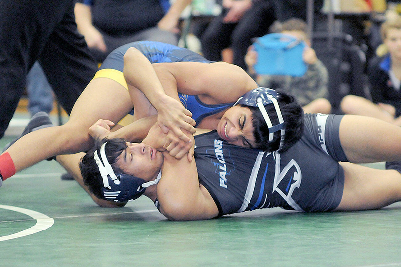 KEITH THORPE/PENINSULA DAILY NEWS
Bryan Lucas of Forks tries to pin Ravi Neumeyer of South Whidbey in the 120 lb. class on Saturday at the Battle of the Ax in Port Angeles.