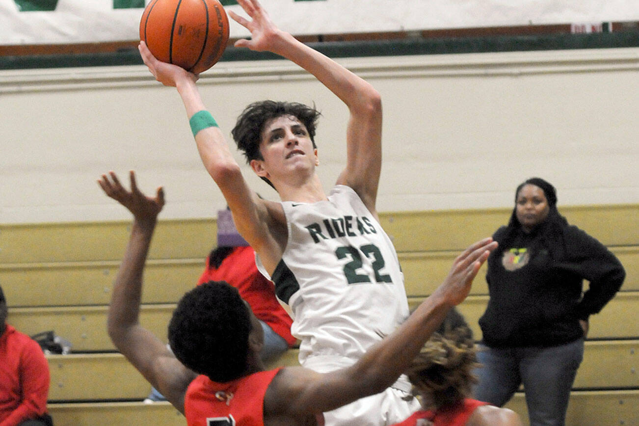 Keith Thorpe/Peninsula Daily News
Port Angeles' Tyler Hunter, center, takes aim over the heads of Franklin Pierce defenders Hakeen Collins, left, and Mason Thomas during Friday's bi-district playoff at Port Angeles High School.