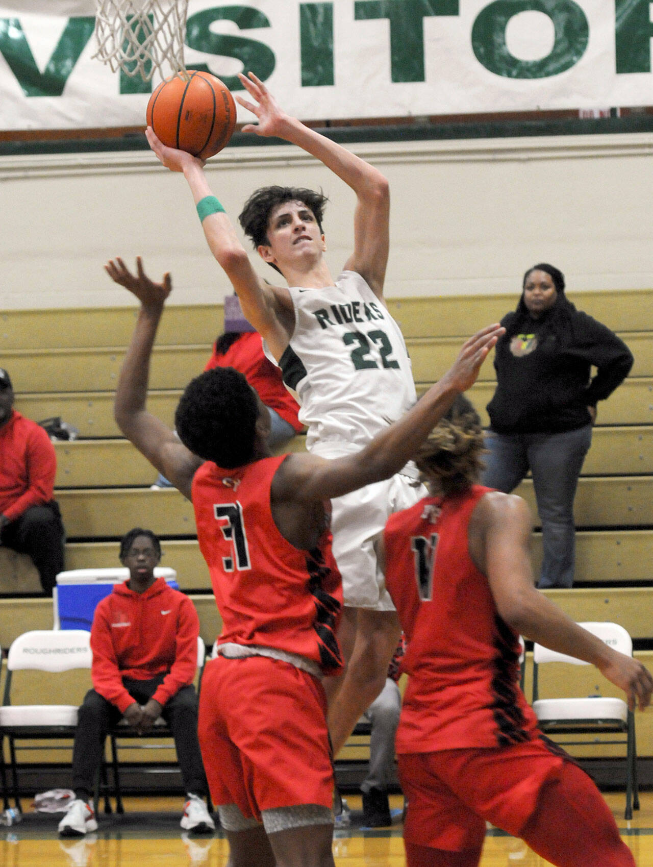 Port Angeles’ Tyler Hunter, center, takes aim over the heads of Franklin Pierce defenders Hakeen Collins, left, and Mason Thomas during Friday’s bi-district playoff at Port Angeles High School. (Keith Thorpe/Peninsula Daily News)