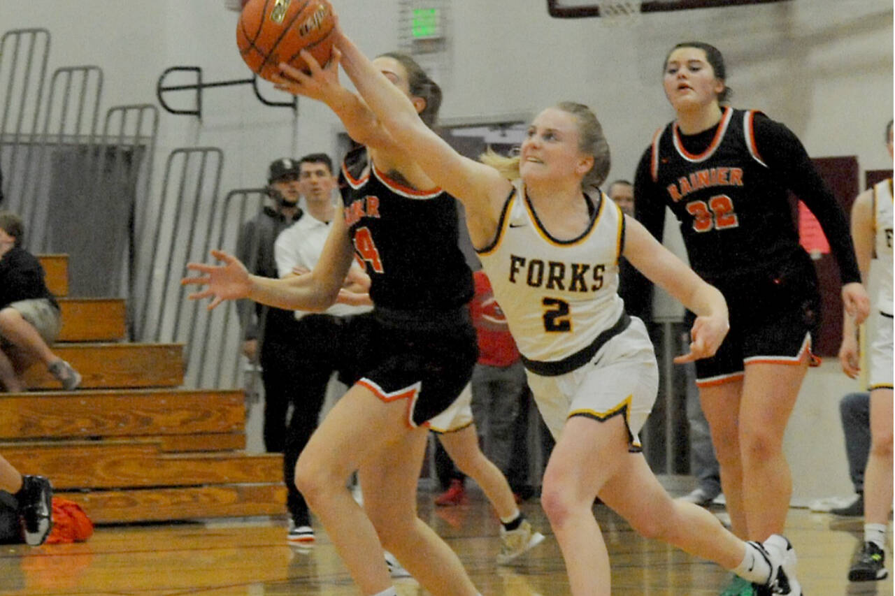 Lonnie Archibald/for Peninsula Daily News
Forks' Kadie Wood (2) fights for control of the ball against Rainier Saturday at W.F. West High School  in Chehalis during the 2B District 4 play-offs Saturday.