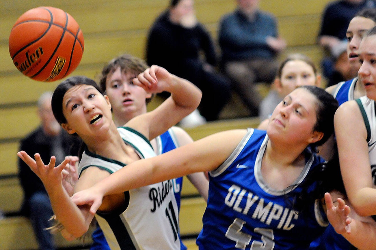 KEITH THORPE/PENINSULA DAILY NEWS
Port Angeles' Lindsay Smith, left, stretches for a rebound as Olympic's Kylee Murphy during a Jan. 20 game in Port Angeles. The Roughriders play in regionals Friday night.