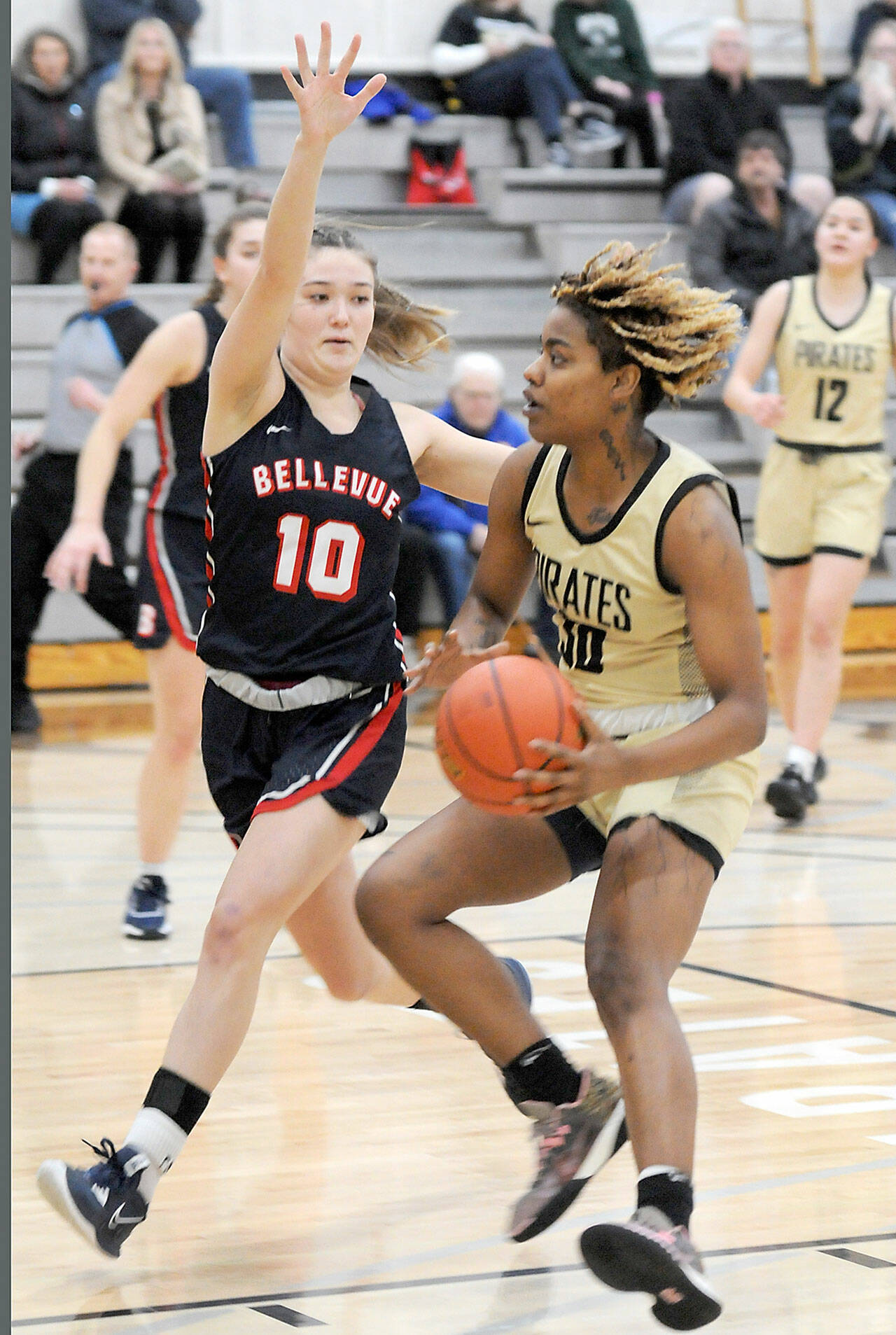 Peninsula’s Chasity Selden, right, drives to the lane as Bellevue’s Jadyn Mueller plays defense Feb. 8 in Port Angeles. (Keith Thorpe/Peninsula Daily News)