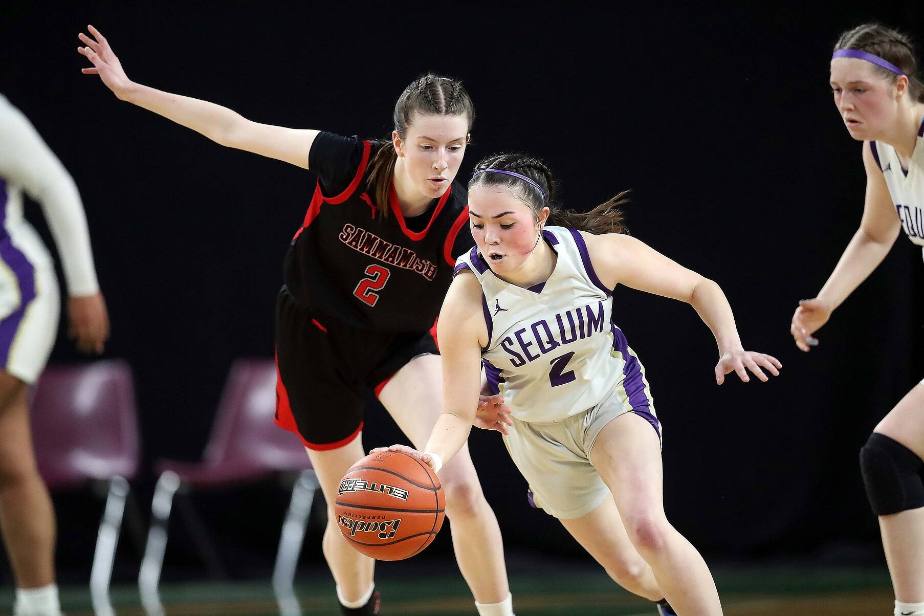 Sequim's Hannah Bates dribbles against Sammamish Sarah Shaggs in the state 2A tournament Wednesday night. Bates finished with 14 points, seven rebounds and six steals in a 57-37 Sequim victory. (David Willoughby/for Peninsula Daily News)