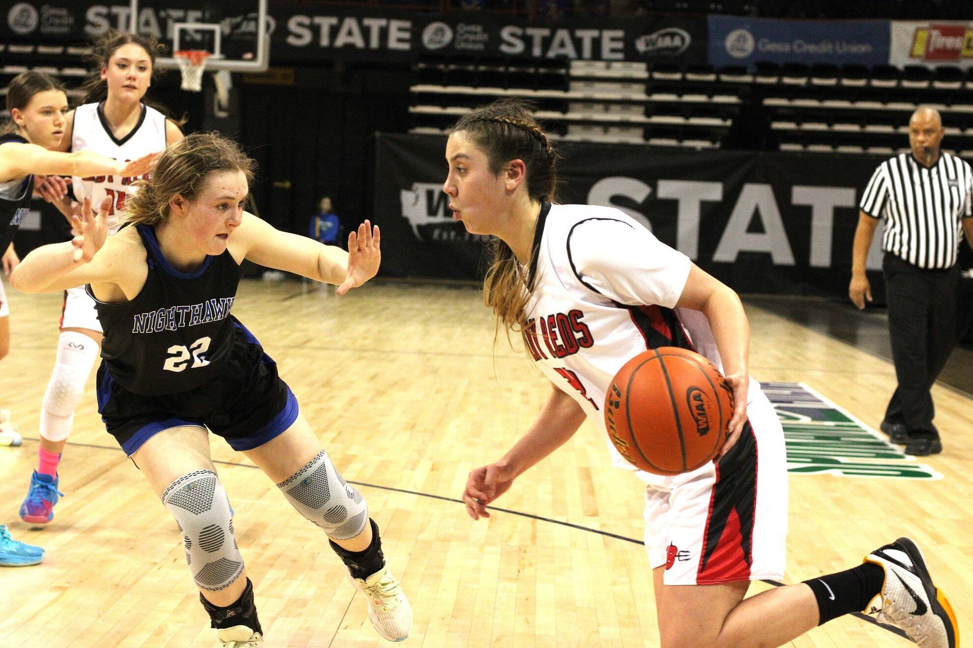 Neah Bay's Ryana Moss drives against Oakedale's Samantha Holling Thursday morning at the Spokane Arena during the 1B state tournament. Moss scored nine points as Neah Bay won 60-45 to move into the state 1B semifinals. (Byrne Bennett/Cheney Free Press)